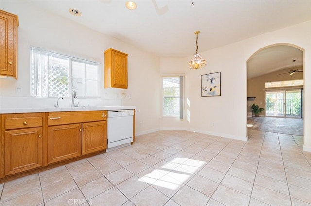 kitchen featuring light tile patterned flooring, white dishwasher, and a sink