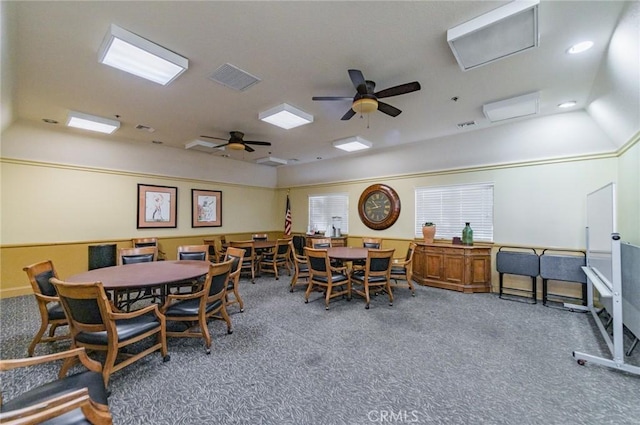 dining area with lofted ceiling, attic access, visible vents, and carpet floors