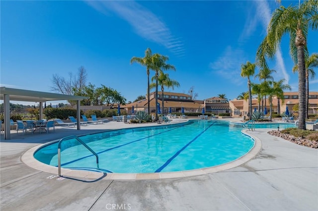 pool featuring a patio area and fence