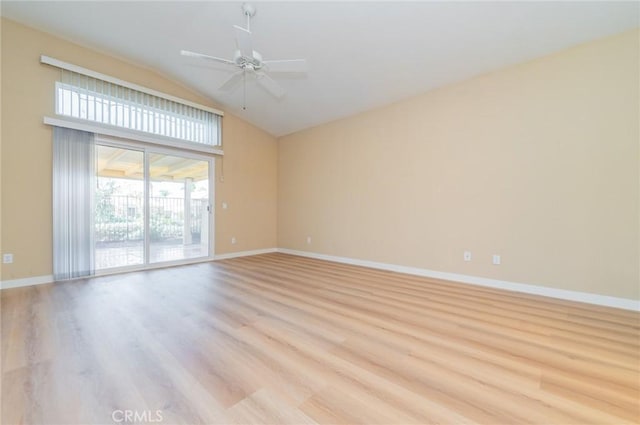 empty room featuring vaulted ceiling, a ceiling fan, baseboards, and light wood finished floors