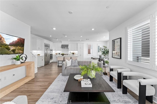 living room featuring light wood-type flooring and recessed lighting