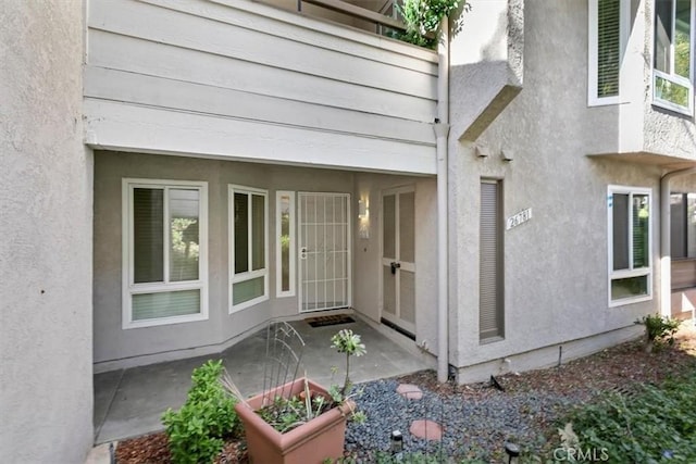 doorway to property with stucco siding