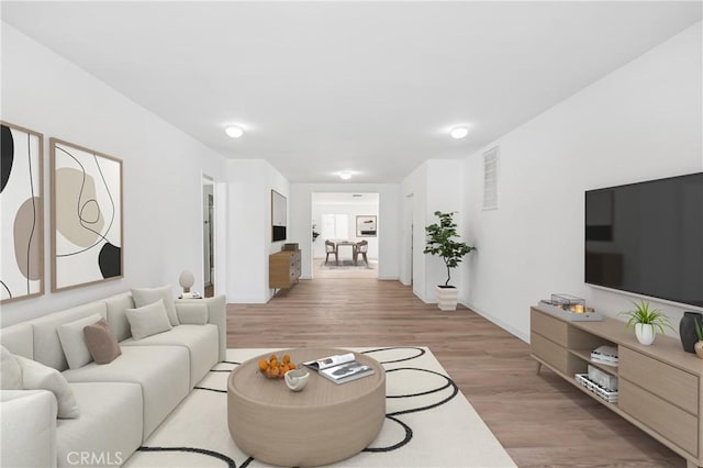 living room featuring light wood-type flooring and visible vents