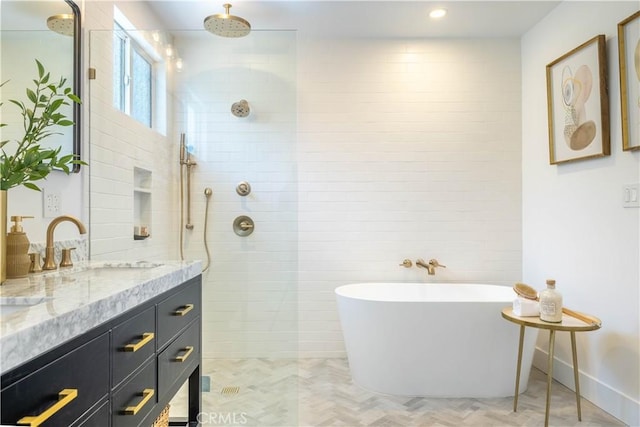 full bath featuring recessed lighting, a soaking tub, vanity, and a walk in shower