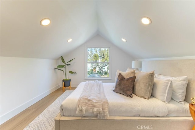 bedroom with vaulted ceiling, recessed lighting, wood finished floors, and baseboards