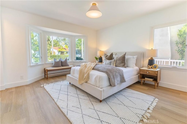 bedroom with wood finished floors and baseboards