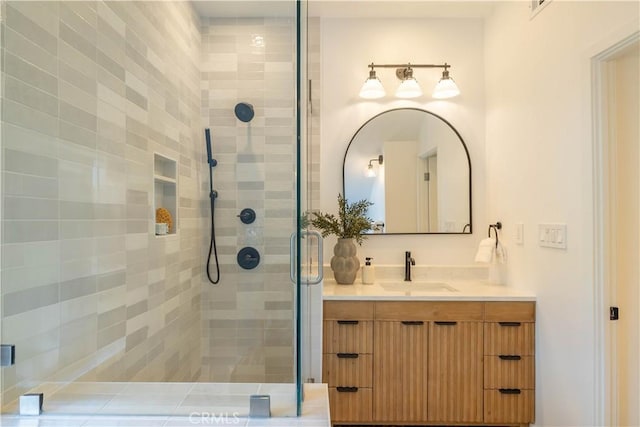 bathroom featuring vanity and a shower stall