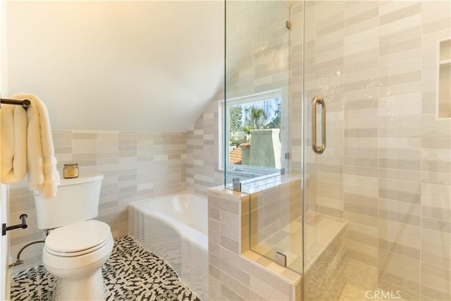 full bathroom featuring toilet, a garden tub, vaulted ceiling, a stall shower, and tile walls