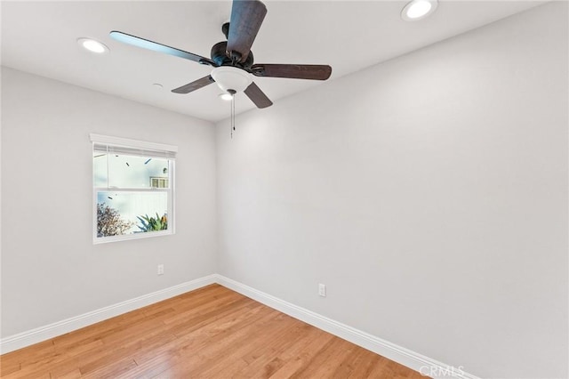 empty room with a ceiling fan, recessed lighting, baseboards, and wood finished floors