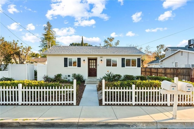 view of front of home featuring a fenced front yard and stucco siding