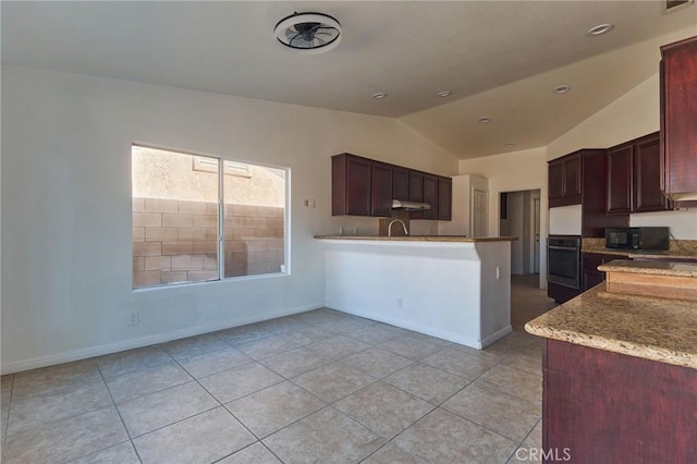 kitchen featuring lofted ceiling, stainless steel oven, black microwave, under cabinet range hood, and baseboards