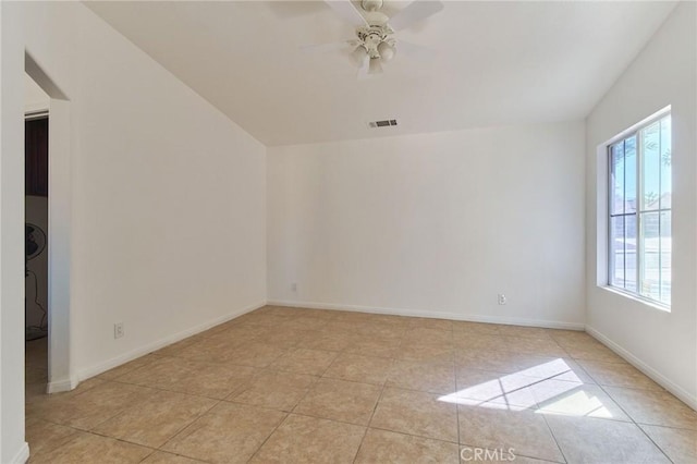 unfurnished room with a ceiling fan, visible vents, baseboards, and light tile patterned floors