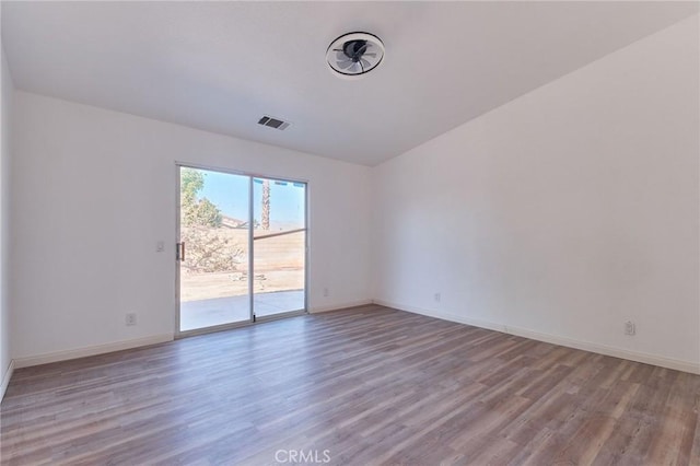 unfurnished room with baseboards and light wood finished floors