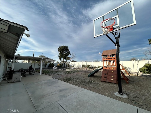 exterior space with a patio area, a playground, and a fenced backyard