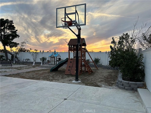 exterior space featuring a playground and a fenced backyard