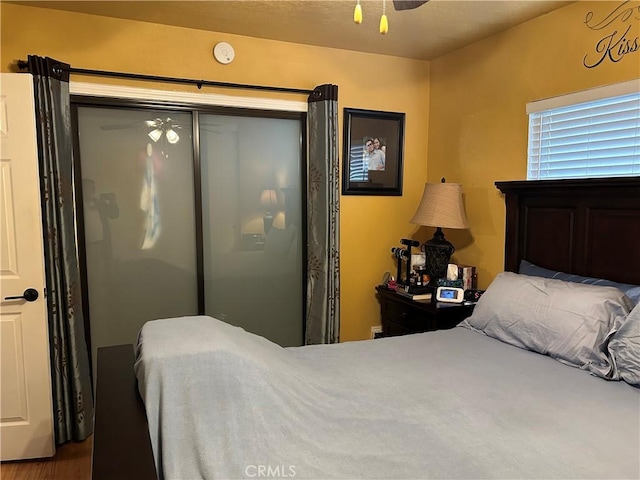 bedroom with ceiling fan and a closet