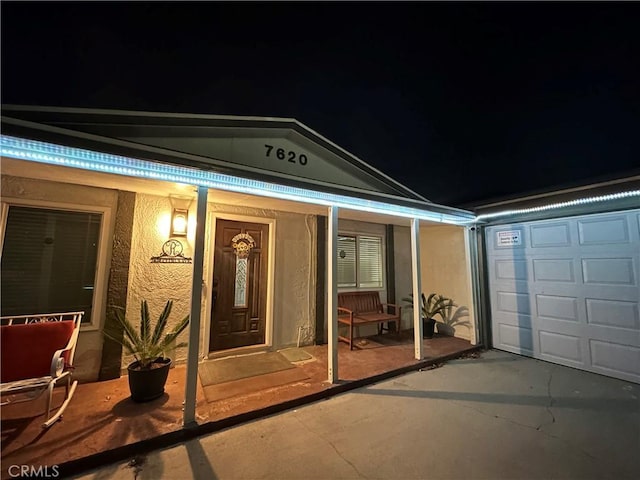 exterior entry at twilight with a patio area