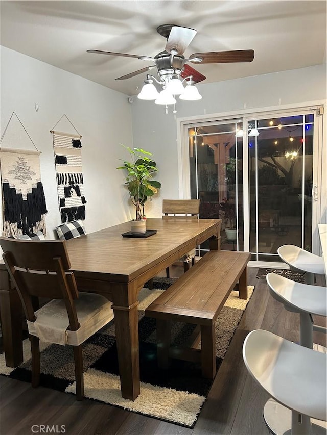 dining area featuring ceiling fan and dark wood-style flooring