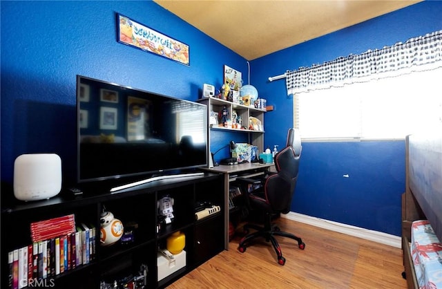 office space featuring baseboards and wood finished floors