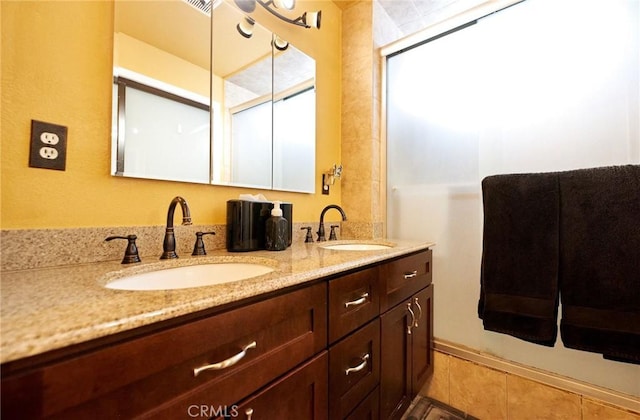full bathroom featuring tile patterned flooring, a sink, and double vanity