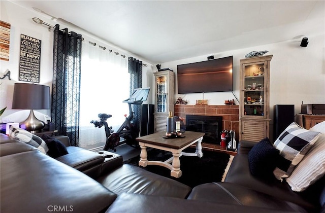 living room with a tile fireplace