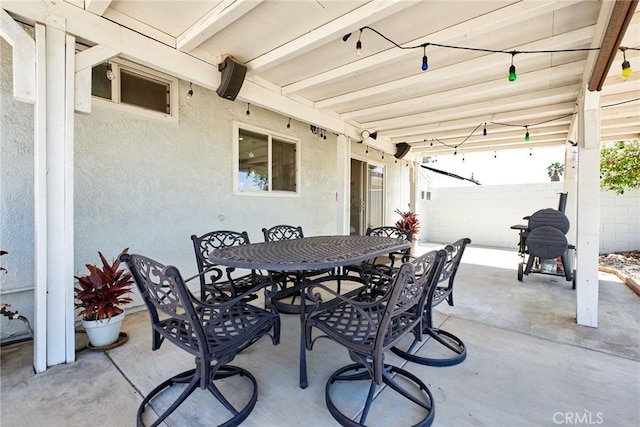 view of patio with fence and outdoor dining area