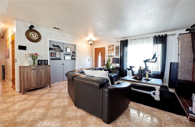 living room with visible vents and light tile patterned floors