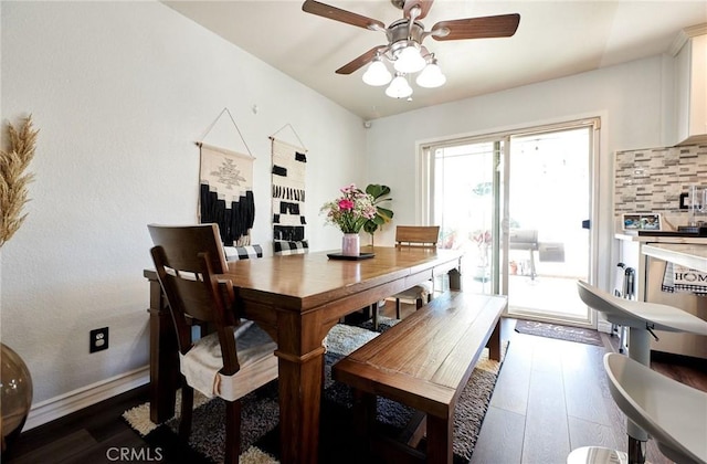 dining room featuring dark wood finished floors, baseboards, and a ceiling fan