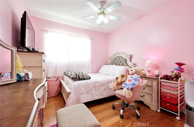 bedroom with ceiling fan and wood finished floors