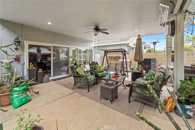 view of patio featuring ceiling fan, an outdoor living space, and fence