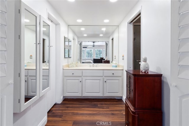 ensuite bathroom featuring recessed lighting, vanity, wood finished floors, and ensuite bathroom