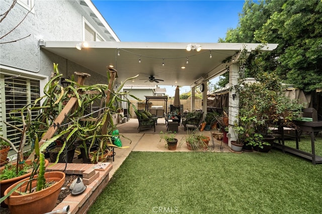 view of yard featuring ceiling fan, a fenced backyard, and a patio