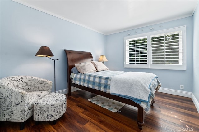 bedroom featuring crown molding, baseboards, and dark wood-style flooring