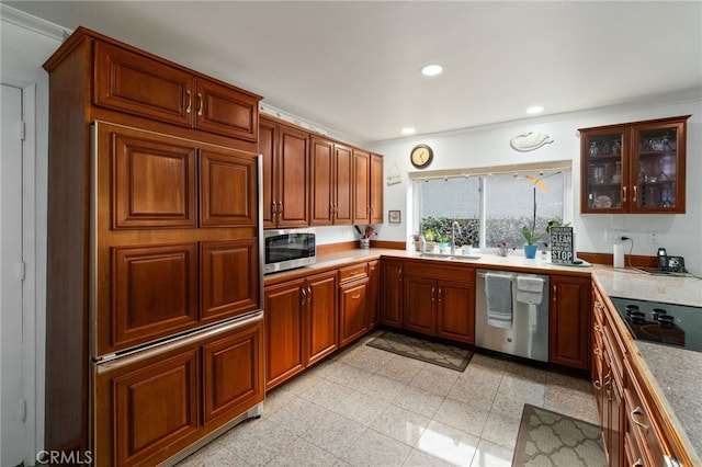 kitchen featuring brown cabinets, appliances with stainless steel finishes, a sink, and recessed lighting