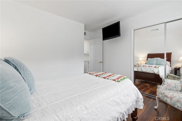 bedroom with wood finished floors and visible vents