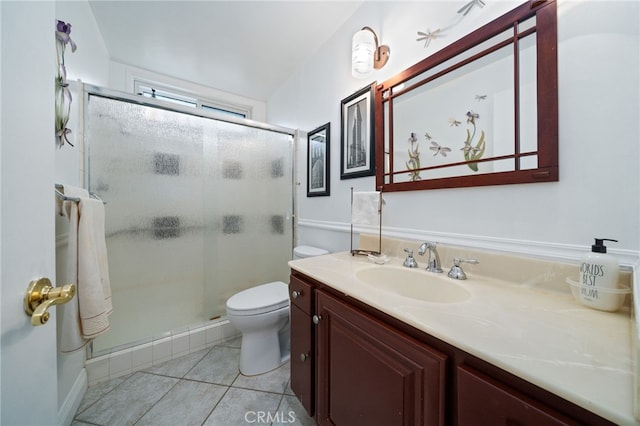 bathroom with vanity, tile patterned flooring, a shower stall, and toilet