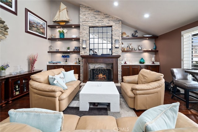 living area with recessed lighting, vaulted ceiling, a fireplace, and wood finished floors