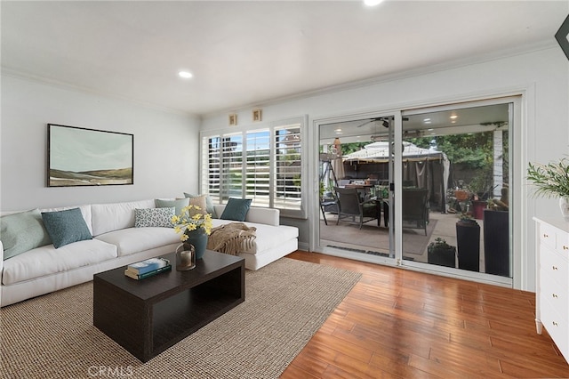 living room featuring recessed lighting, crown molding, and wood finished floors