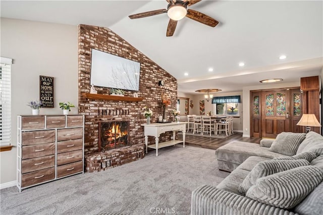 living room featuring carpet, a fireplace, lofted ceiling, recessed lighting, and a ceiling fan