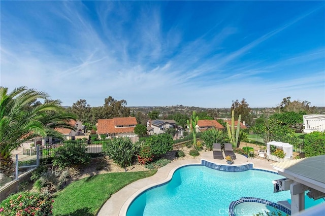 view of swimming pool with a patio area, a fenced backyard, and a pool with connected hot tub