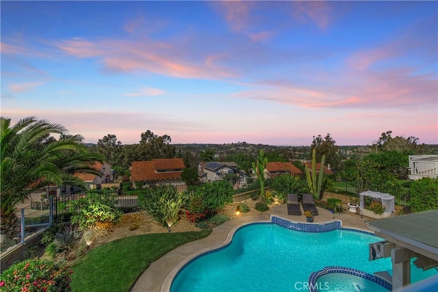 view of pool featuring a patio, a fenced backyard, and a pool with connected hot tub