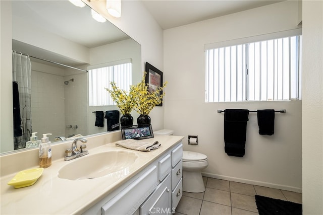 full bath with a healthy amount of sunlight, tile patterned flooring, toilet, and vanity