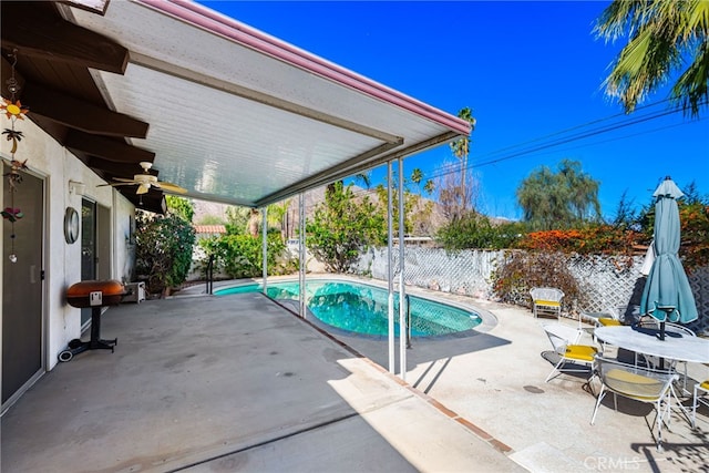 view of pool featuring a patio area, a fenced backyard, a fenced in pool, and a ceiling fan