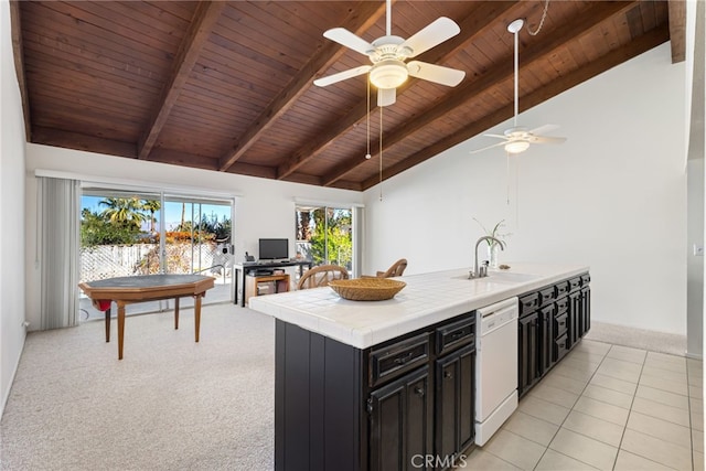 kitchen with dishwasher, tile countertops, dark cabinets, beam ceiling, and a sink