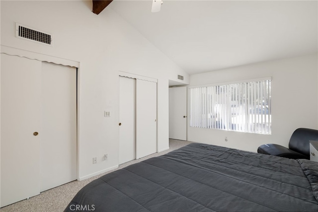 bedroom with multiple closets, beam ceiling, and visible vents