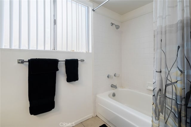 full bathroom featuring plenty of natural light, tile patterned flooring, baseboards, and shower / bath combo with shower curtain