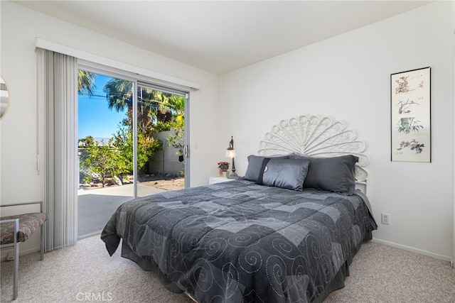 bedroom with access to exterior, light colored carpet, and baseboards