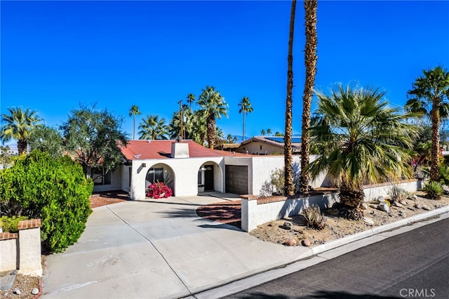 mediterranean / spanish home with driveway, an attached garage, and stucco siding