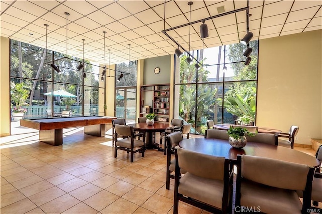 tiled dining area featuring expansive windows