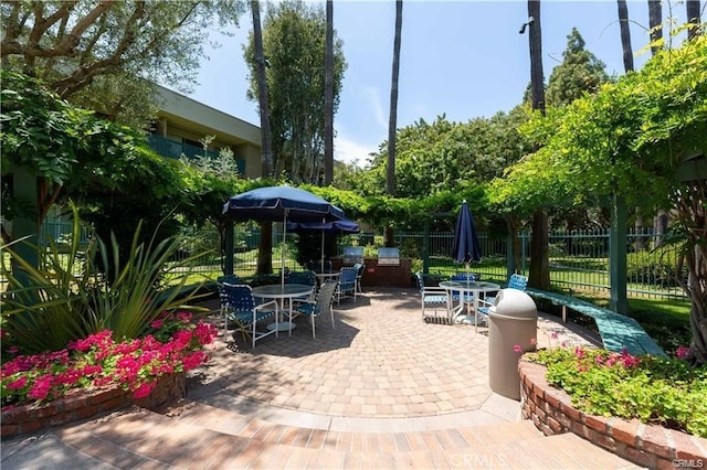 view of patio / terrace featuring fence and outdoor dining space